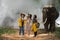 Asian tourists and tourists guides are watching elephants in the jungle