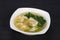 Asian traditional Wonton soup with herbs