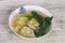 Asian traditional Wonton soup with herbs