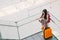 Asian traveler girl, college student using smartphone call or chat at airport with luggage, backpack. Web check in, lonely travel