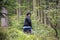 Asian traveler thai old woman walking in the forest at black forest