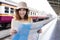 Asian traveler woman looking map at train station find destination.