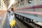 Asian traveller with travel bag wait a train in Chiang mai train station