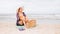 Asian traveller woman sit back and relax on the beach by the sea background on weekend vacation.Concept of happy solo travel