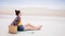 Asian traveller woman sit back and relax on the beach by the sea background on weekend vacation.Concept of happy solo travel