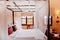 Asian tropical bedroom four poster bed white curtain and armchairs