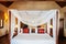 Asian tropical bedroom four poster bed white curtain and wooden closet