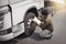 Asian a truck driver holding clipboard inspecting safety check a truck tires. vehicle maintenance checklist a semi truck	