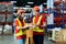 Asian two engineer team shipping order detail on tablet check goods and supplies on shelves with goods background inventory in