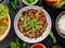 Asian udon noodles with spicy soy sauce and chicken pieces, top view