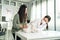 Asian veterinarian examine cat during appointment in veterinary clinic. Professional vet doctor woman sit on table, work and check