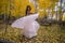 Asian Vietnamese woman in a wedding dress in the yellow autumn aspen trees of Colorado