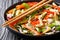 Asian vitamin vegetable salad with sesame and peanuts close-up on a plate. horizontal