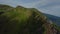 Asian volcano mountain summit people tourist on cliff peak valley countryside scenery aerial view