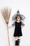 Asian witch child holding magic broom