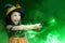 Asian witch little girl using the wand with a magic shine with mystical fire