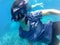 Asian woamn in snorkeling mask dive underwater