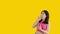 Asian woman acting shocked or surprised isolated on a Yellow background