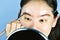 Asian woman applying cosmetics makeup, Eyebrows template head strap use for shaping perfect brows.