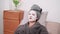 An Asian woman is applying a face mask for a rejuvenating skincare routine, nurturing her skin\'s health and radiance