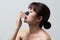 Asian woman applying mask charcoal deep cleansing nose pore strip on fresh clean skin