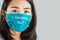 Asian woman asking  word is quarantine over with question mark on protective mask, Corona virus ended concept