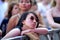 An asian woman from the audience watches a concert at Sonar Festival
