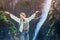 Asian woman with backpack hiking along waterfalls of Pollat river in Schwangau region near Neuschwanstein