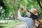 Asian woman backpack traveler use mobile take photo when traveling at rain forest.Holiday vacation