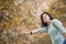 Asian woman Backpacker standing on countryside road and hitchhiking for car with tree in autumn fall seasonal,Alone travel or sin