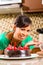 Asian woman baking chocolate cake in kitchen