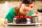 Asian woman baking chocolate cake in kitchen