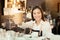 Asian woman barista smiling with a cup of coffee in her hand