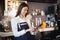 Asian woman barista smiling with tablet in her hand,Female employees are taking orders from online customers