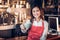 Asian woman barista wear red apron holding hot coffee cup and sm