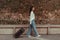 Asian woman beaming carrying a suitcase black to travel on vacation, Trolley bag