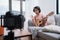 Asian woman blogger recording and live steam playing guitar on social media