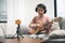 Asian woman blogger recording and live steam playing guitar on social media