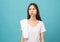 Asian woman brushing teeth and towel on the shoulder on blue background, Concept oral hygiene and health care