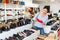 Asian woman buying new footwear in shoe store