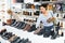 Asian woman buying new footwear in shoe store