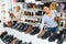 Asian woman buying new footwear in shoe store