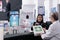 Asian woman buying supplements at pharmacy store counter desk