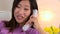 Asian woman calling long distance