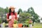 Asian woman care plant flower in garden. People hobby and freelance gardening outdoor