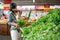 Asian woman carrying her baby while shopping