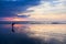 Asian woman catching saltwater fish on the beach at dusk