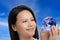 Asian woman celebrating Earth Day isolated on blue sky background