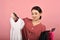 Asian woman choosing cloth in studio shot, What to wear selection for proper dressing.