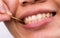 Asian woman clean her teeth from food stuck her teeth with bamboo wood toothpick after breakfast, lunch, dinner. Personal dental